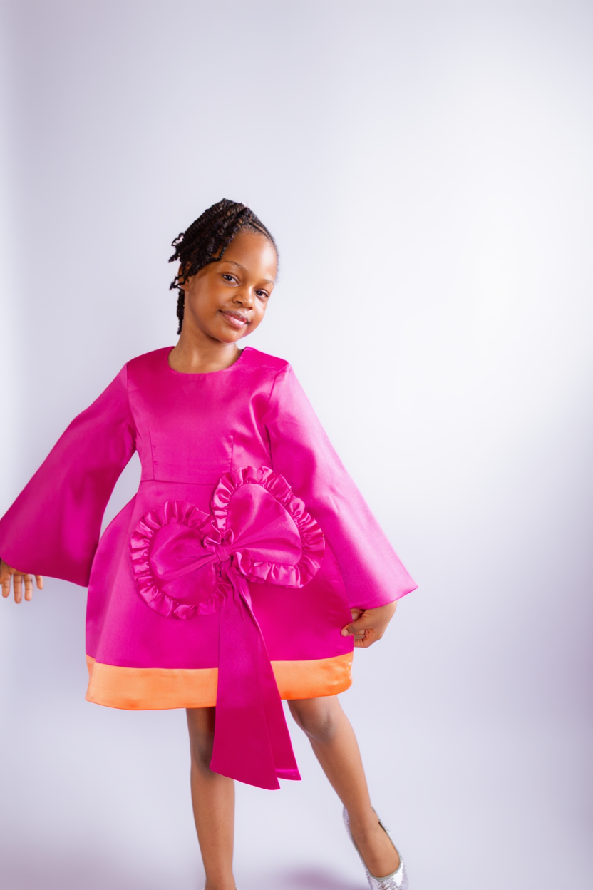 TULIP BOW DRESS β Exaggerated-hip dress with a frilled statement front bow and contrast hem.