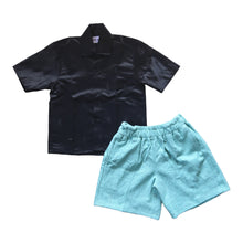 Load image into Gallery viewer, Black embossed shirt and blue shorts
